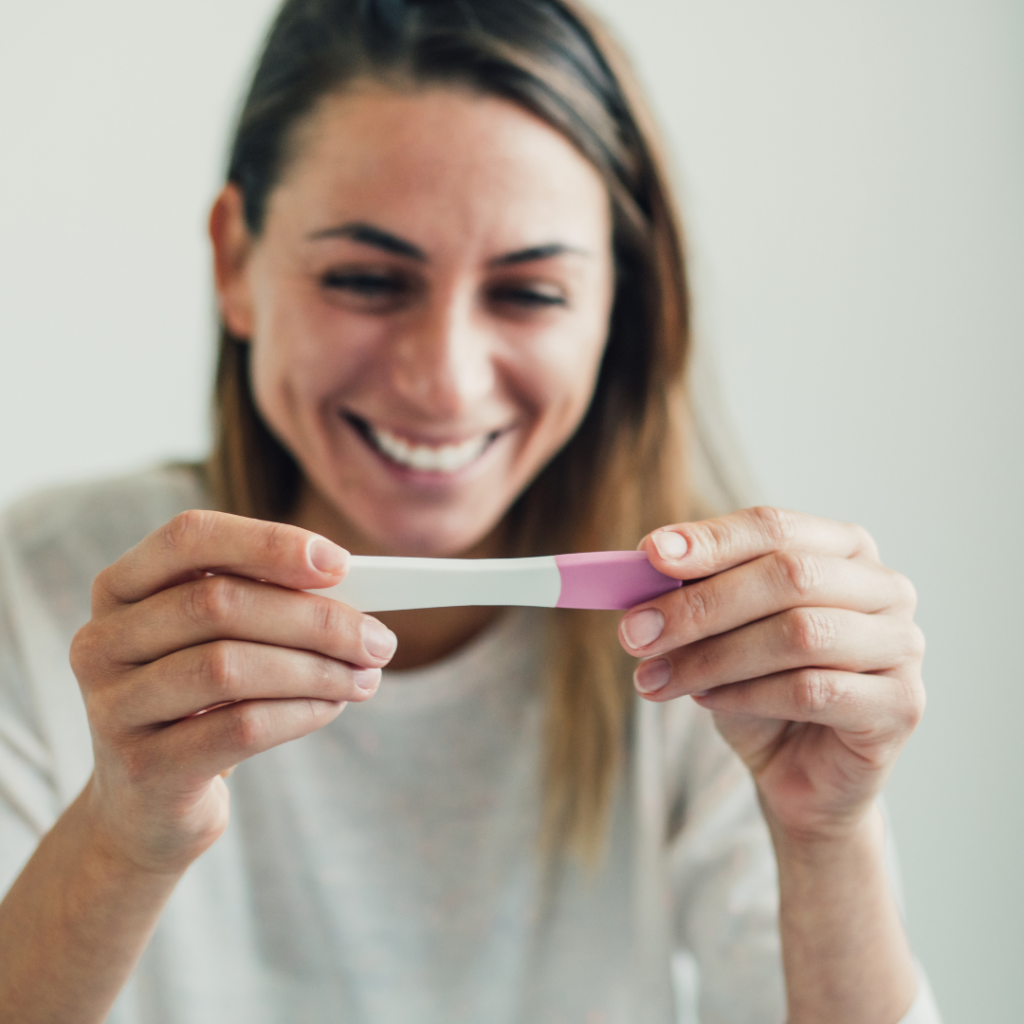 Woman with positive pregnancy test